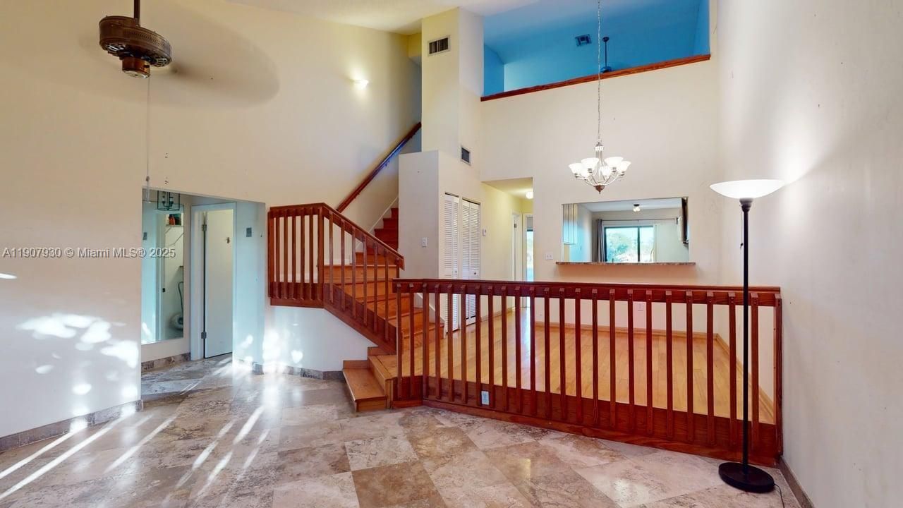 Elegant upper level vantage point offering a cozy, private escape overlooking the main living area.