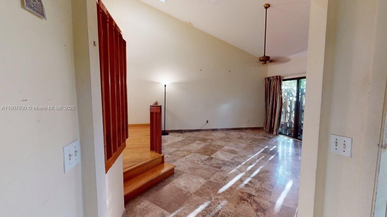 Spacious open-concept living area with soaring ceilings and abundant natural light ideal for entertaining or quiet evenings in.