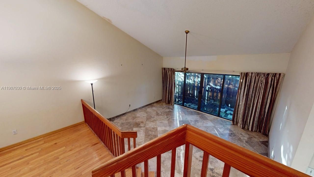 Open loft-style area overlooking the main living space — perfect as a reading nook, workspace, or cozy lounge.