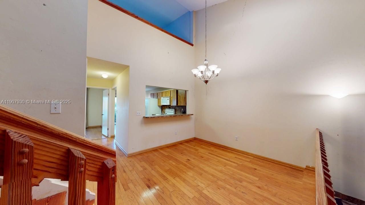 Inviting dining space with warm designer flooring and open concept layout  ideal for entertaining or family gatherings