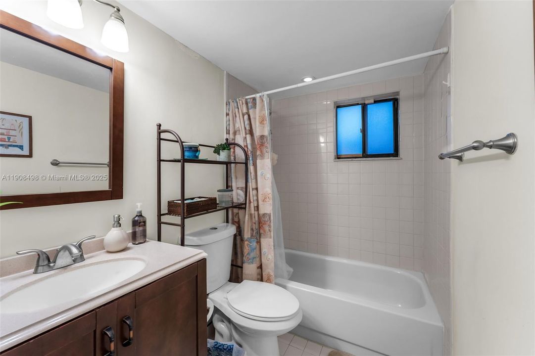 Second bathroom with a tub.