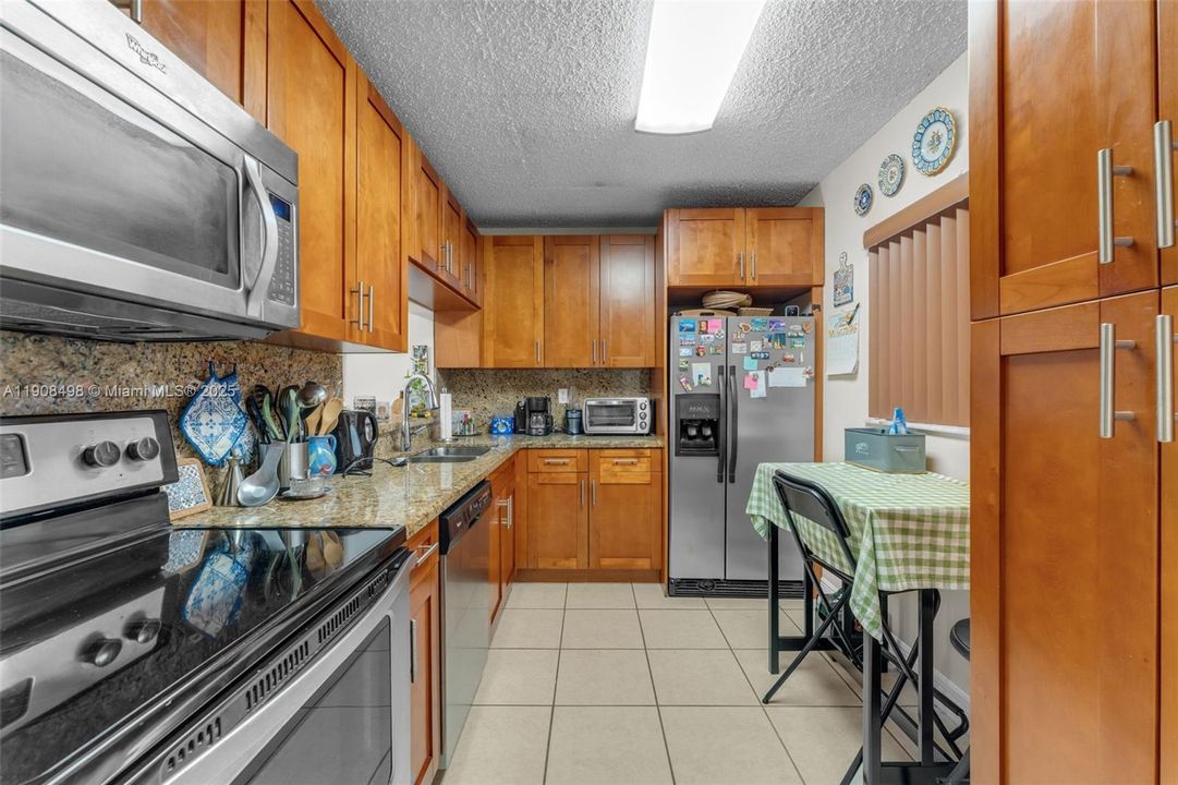 Updated kitchen equipped with full stainless steel appliances.