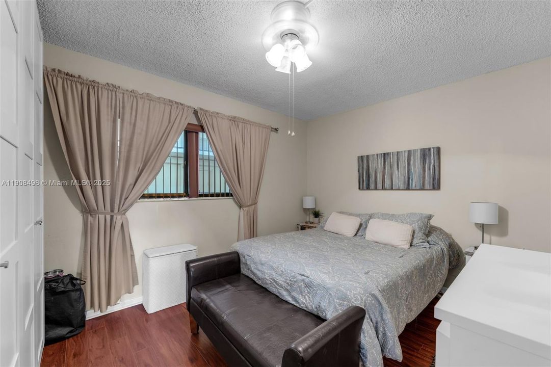 Second bedroom featuring a window that lets in natural light.
