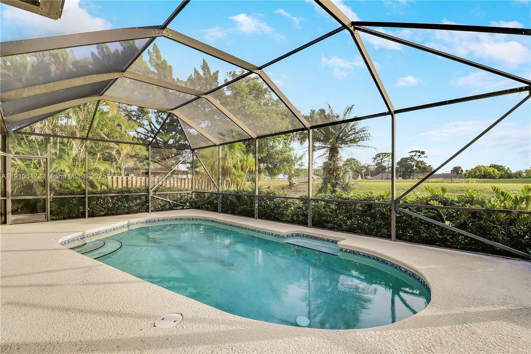 Screen enclosed pool with large patio area