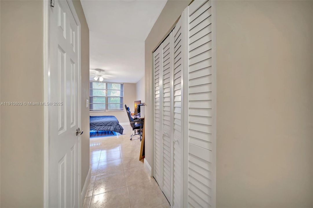 Primary bedroom hallway - Walk-in closet on left, wall closet on right
