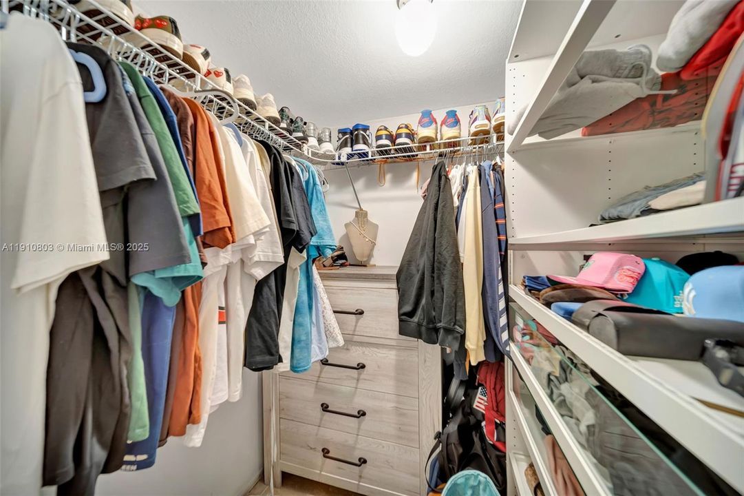 Primary Bedroom walk--in closet - custom shelving