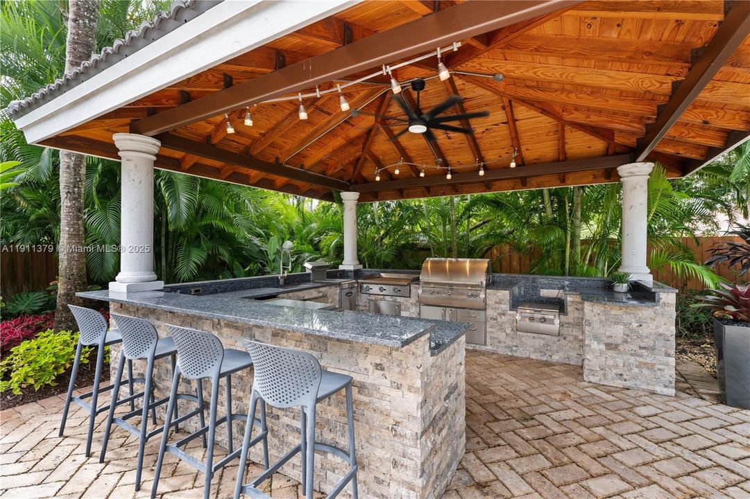 A separate Summer kitchen is set poolside.