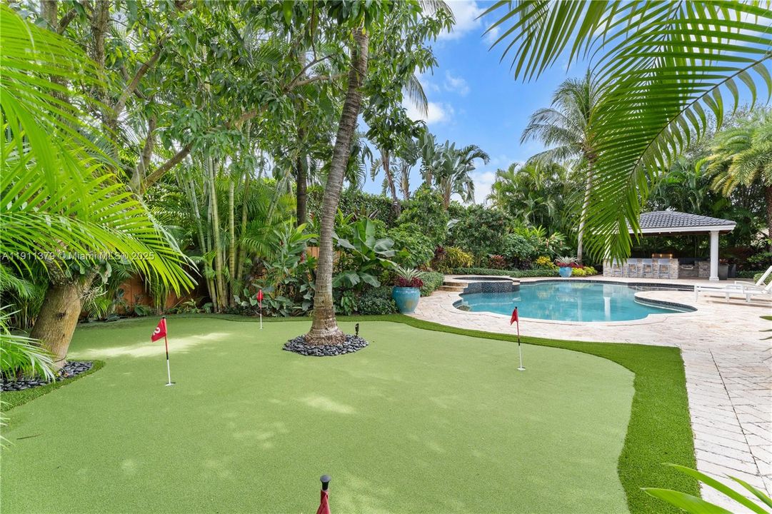 Putting green overlooks the pool & lush gardens
