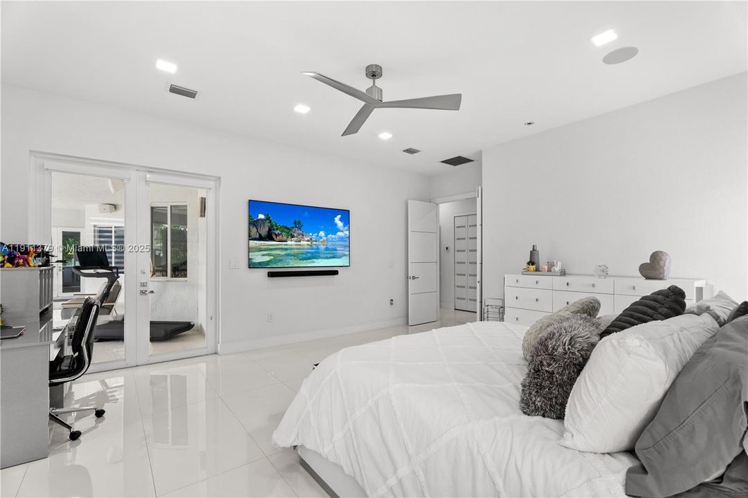 Primary suite opens to large covered living terrace and pool.