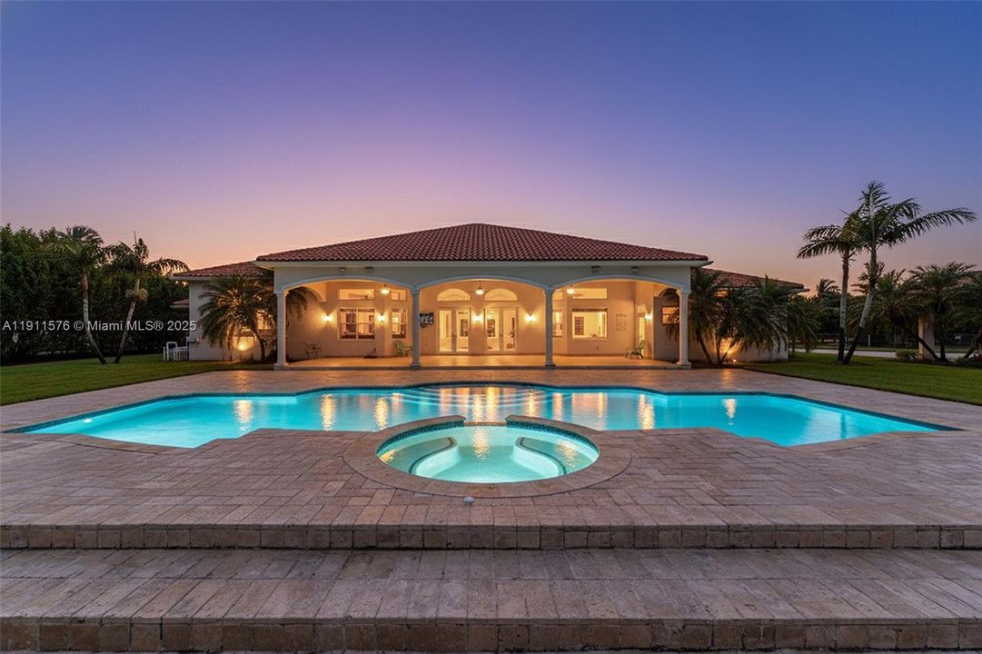 NIGHTIME SCENIC VIEW OF THE POOL AREA