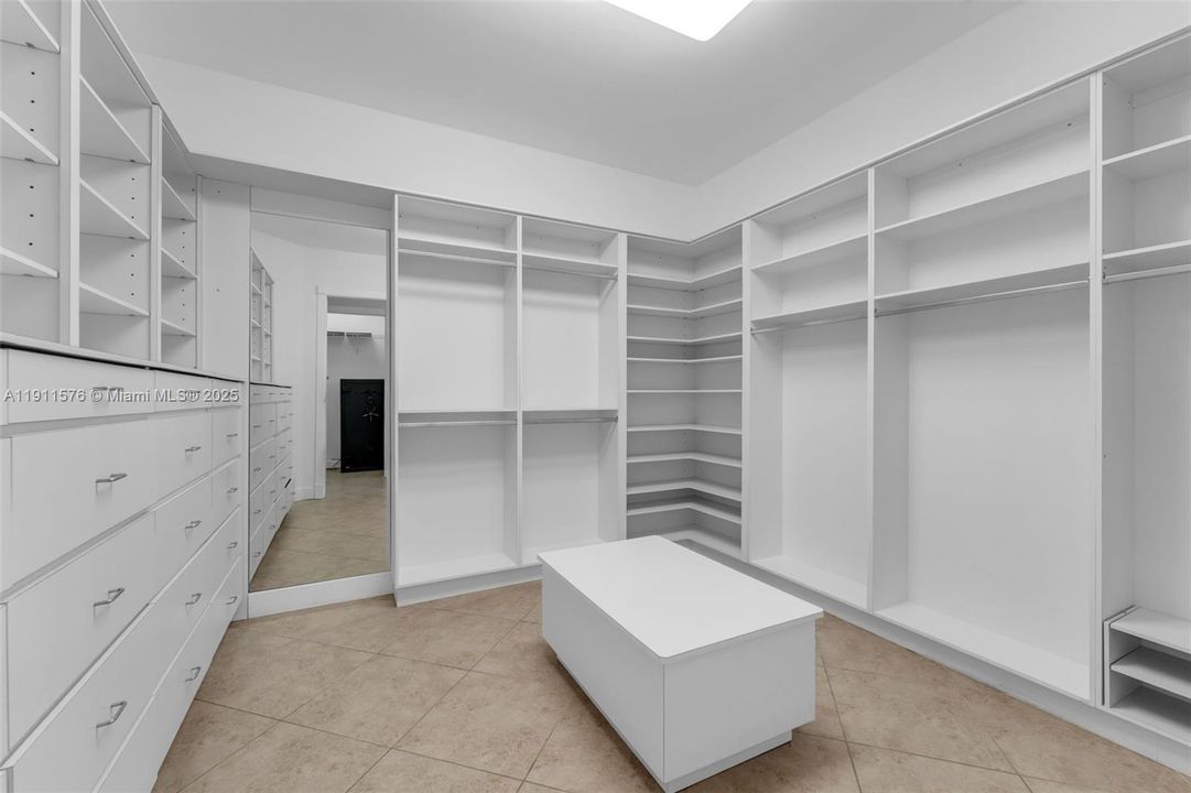 WALK IN CLOSET W/ CUSTOM LIGHTING & CABINETRY IN AIN SUITE