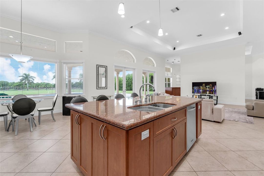 THERE IS AN ADJACENT FAMILY ROOM W BAR... ALL OVERLOOKS POOL PATIO AND GROVES