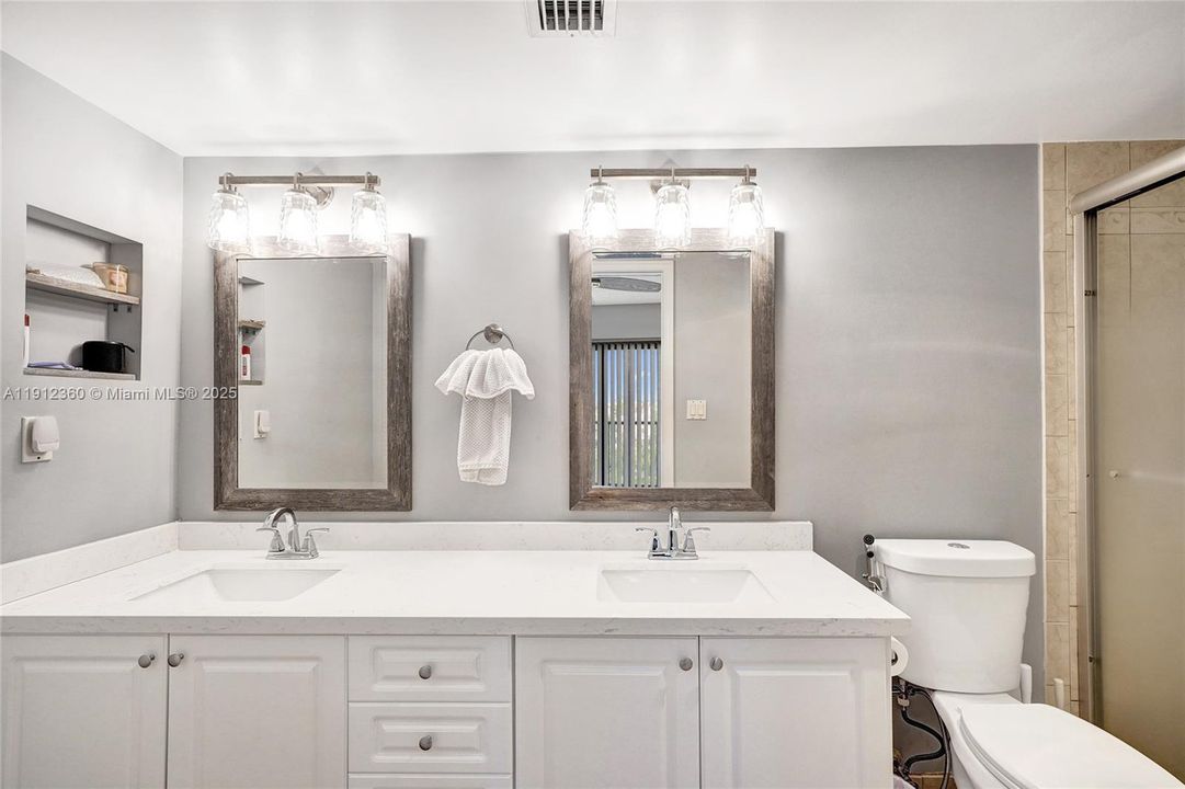 Large spotless primary bathroom with dual sinks.