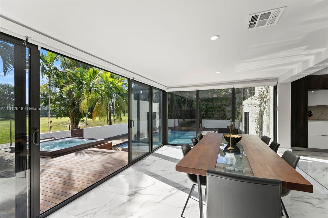 Beautiful view to your pool area and tropical golf course  from your dining area .