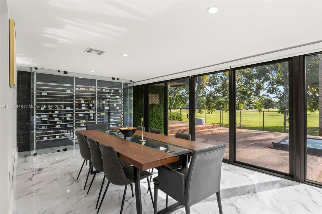Dining Room with custom wine display, overlooking the patio and Golf Course.