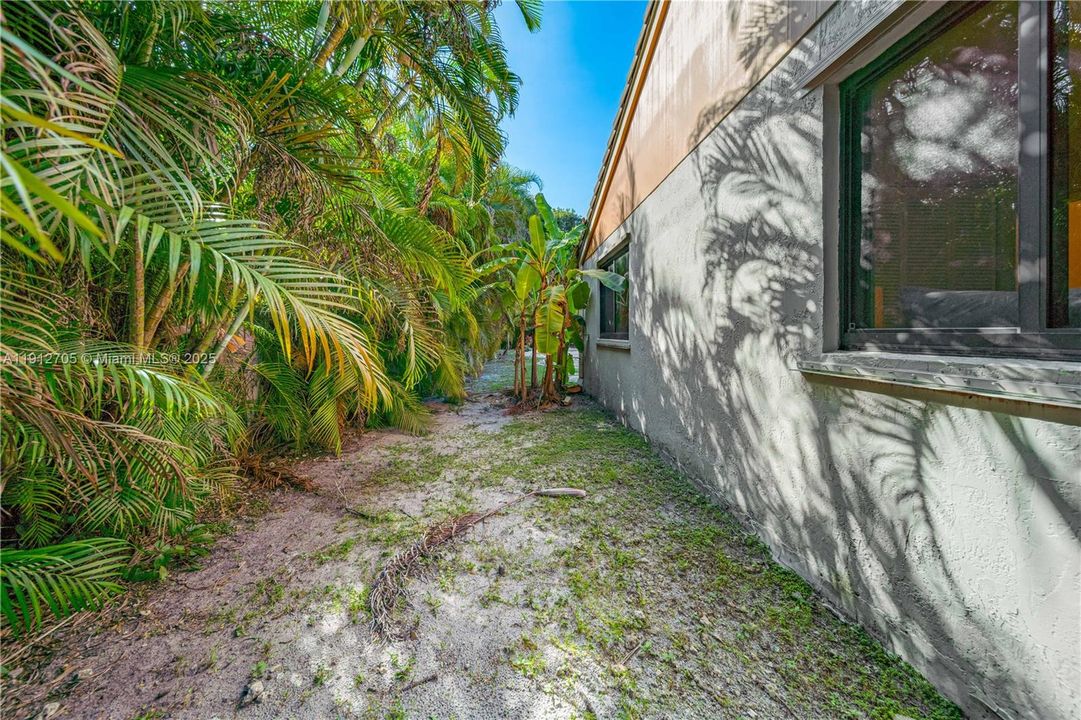 Gated side yard suitable for boat parking.