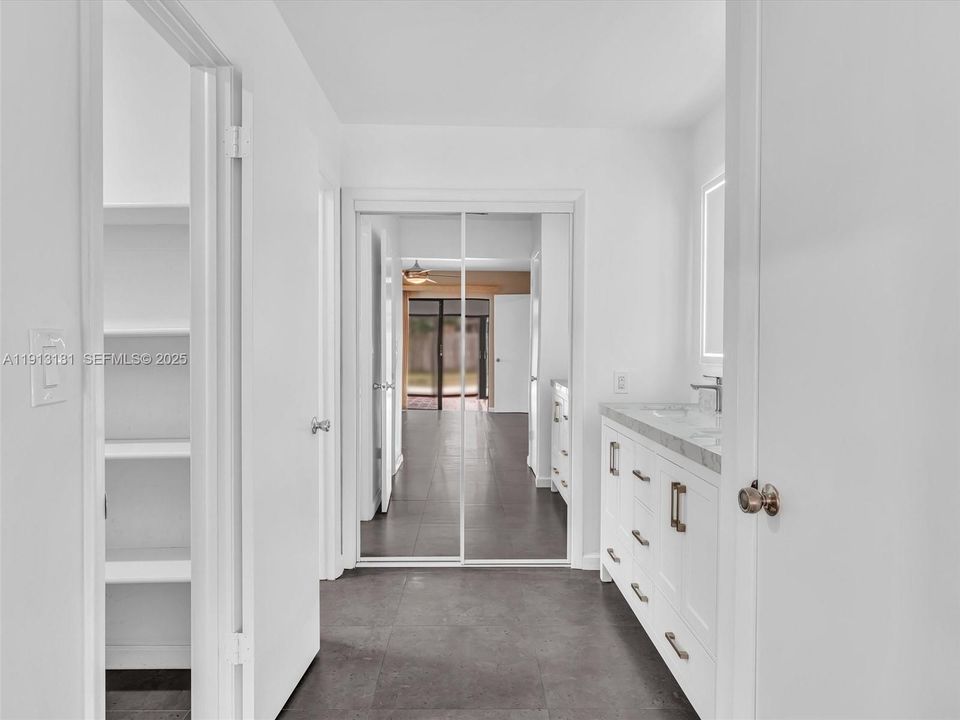 Closets on both sides and in the back of the bathroom