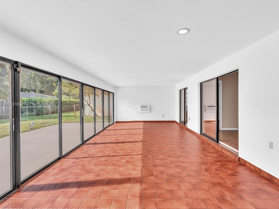 This room features a kitchen pass throuhg window, AC, and access points from the family room, guest bathroom, dining room, and primary bedroom.