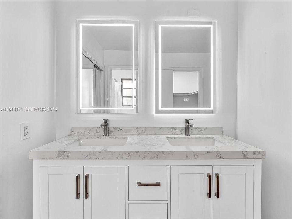 Newly updated with double sink vanity, anti-fog LED mirror, new shower/bath fixtures