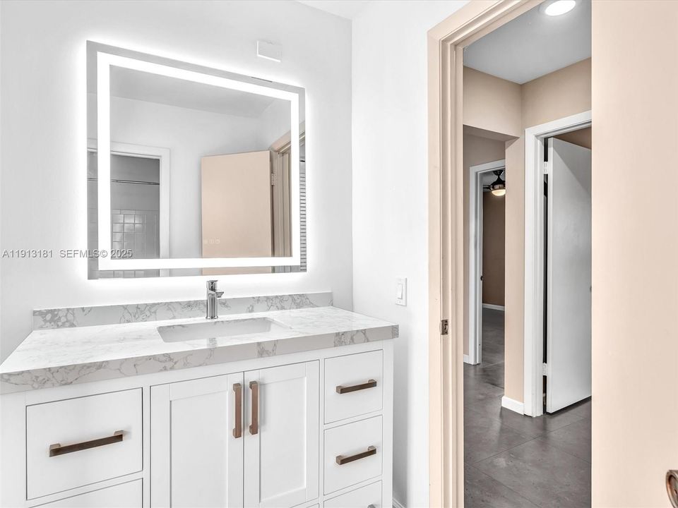 Newly updated with vanity, anti-fog LED mirror, new shower/bath fixtures and a linen closet in the hallway