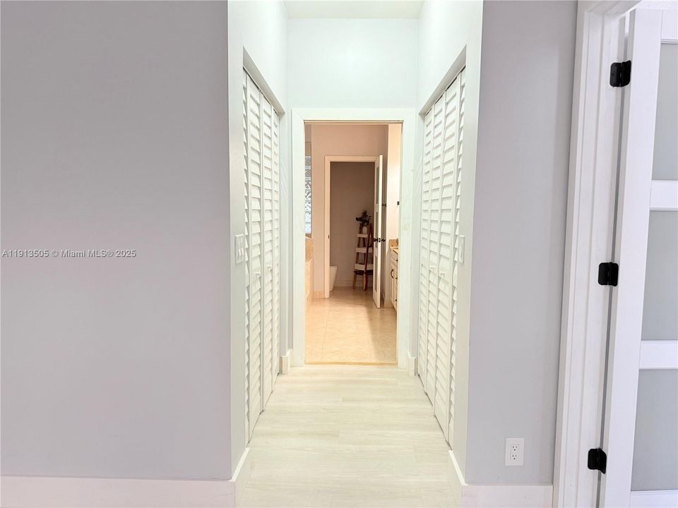 View of His/Her Closets and Master Bathroom