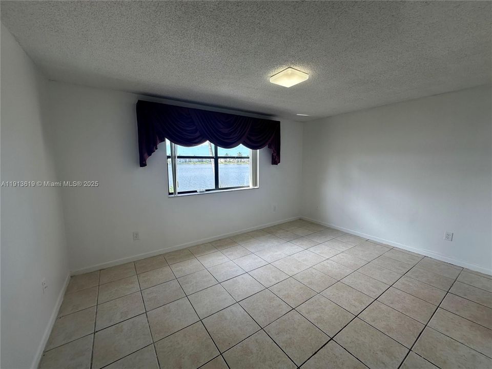 LARGE PRIMARY BEDROOM WITH LAKE VIEWS