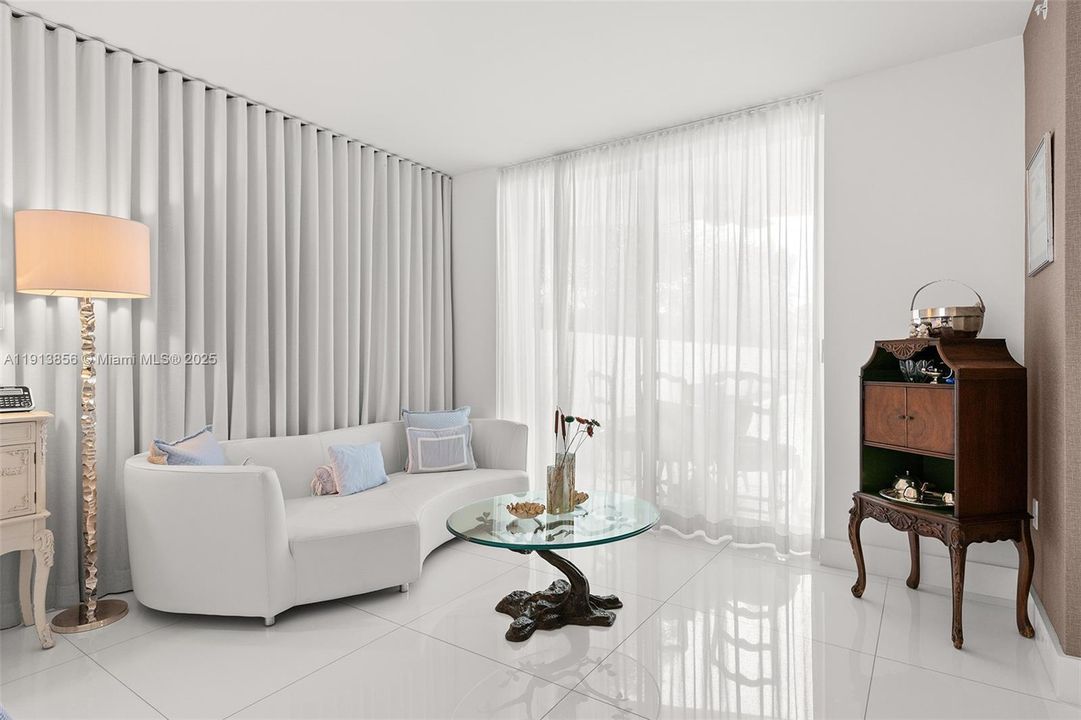 Sitting area in the primary bedroom with sliding door to your private, oversized, waterfront patio area