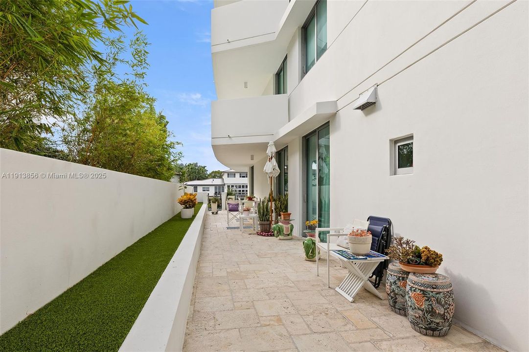 Private side yard running from primary suite all along the residence toward the water