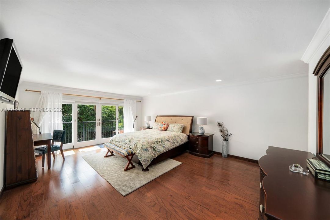 Primary bedroom with balcony and ensuite