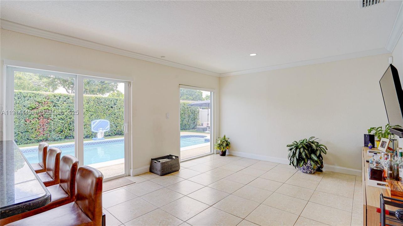 This room can be used as a family, dinning or any other.  It's located between the kitchen and access to the pool.