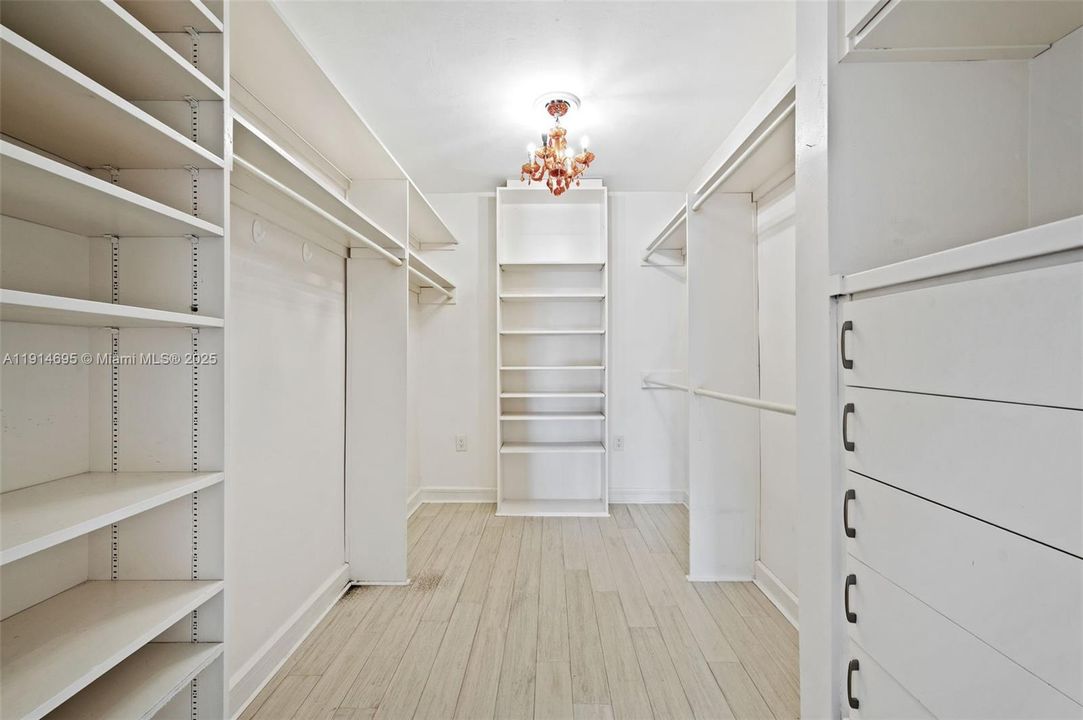HER LARGE BUILT OUT DEEP WALK IN CLOSET