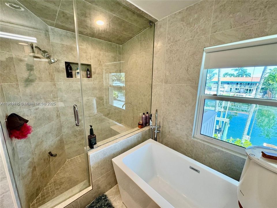 MODERN PRIMARY BATH WITH: STEAM SHOWER, SOAKING TUB AND BIDET & TOILET RM.