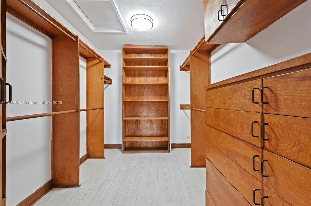 HIS LARGE BUILT OUT DEEP WALK IN CLOSET