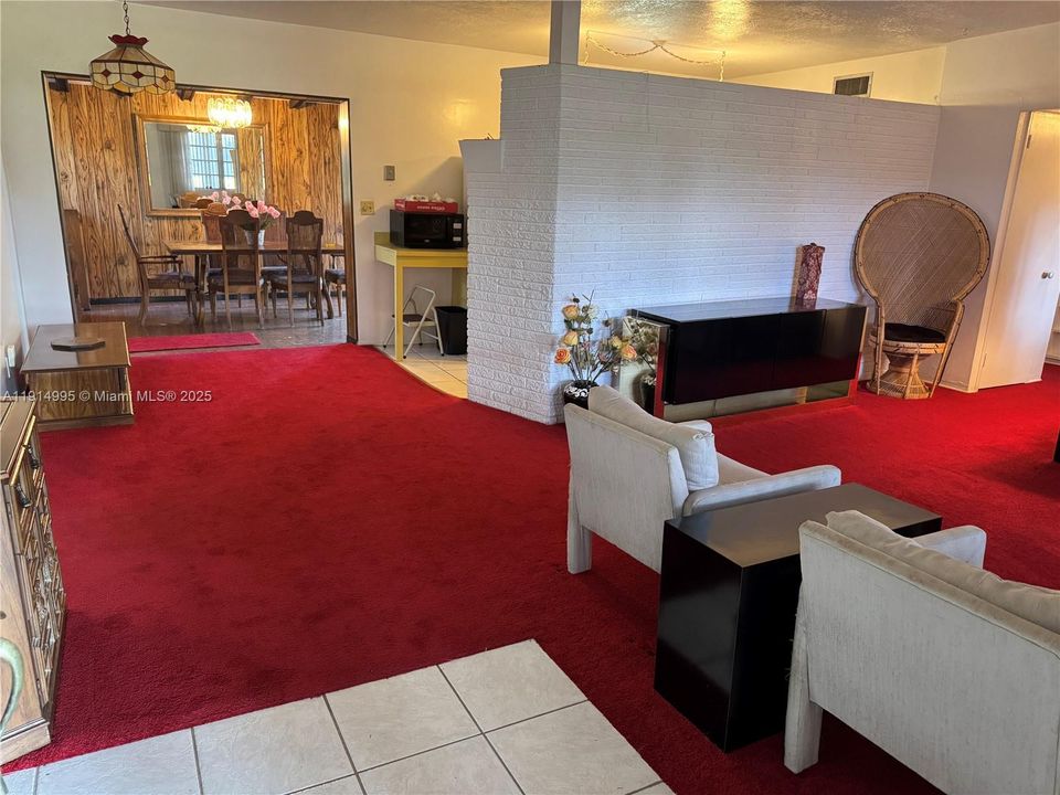 Living room open to galley kitchen, dining room.