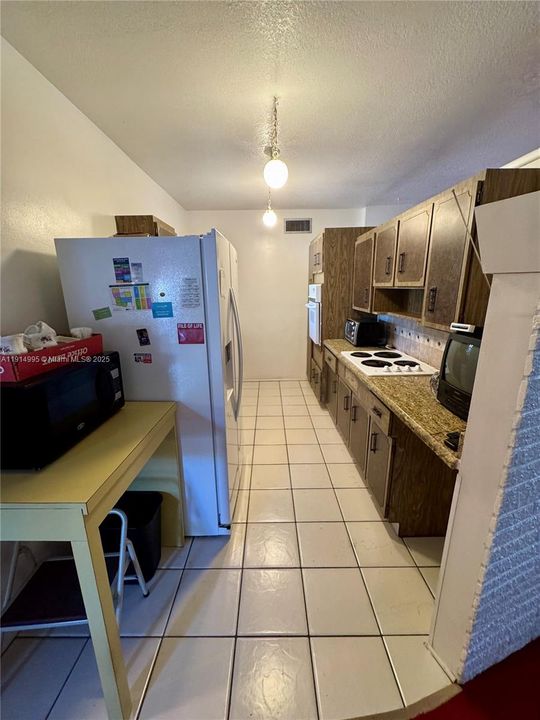 Galley style kitchen - 3/4 wall to living room.