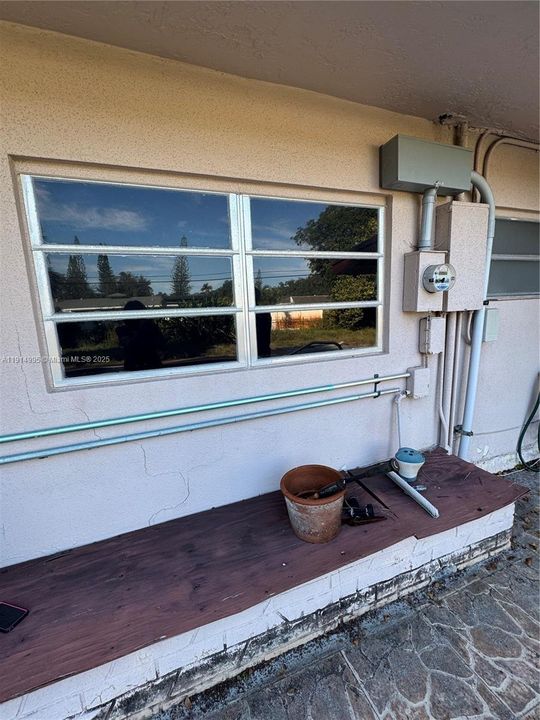 Most of the home has original awning windows, (*4 hurricane impact windows installed on family room,) Power to house with meter..... all electric FPL is underground.