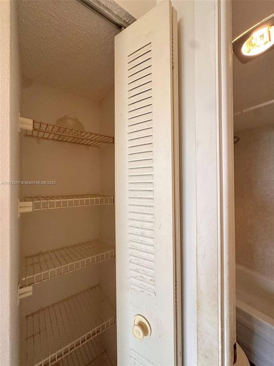 Linen closet by bathroom