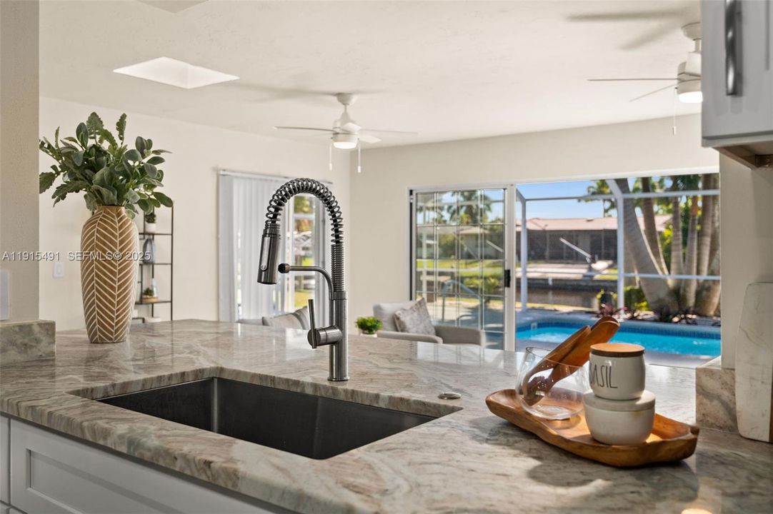 View of the Family room, pool, and canal beyond