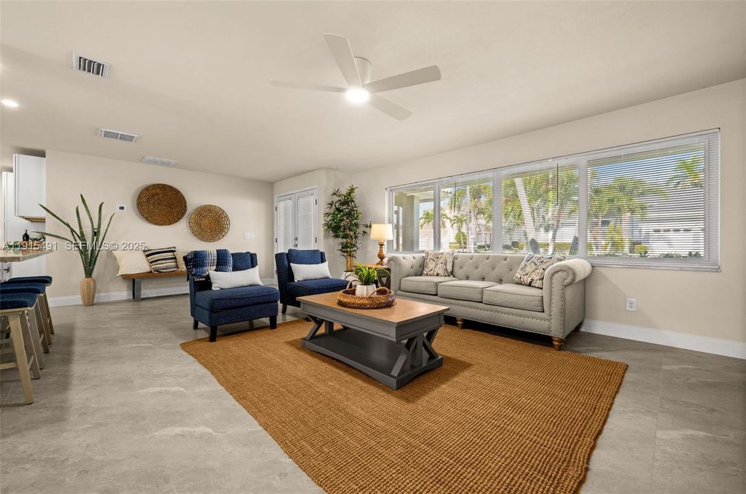 Living room looking toward the kitchen, family room and pool