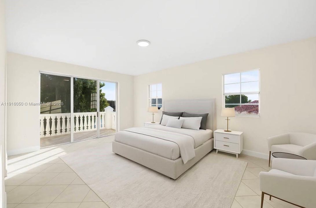 Primary bedroom with sitting area and balcony