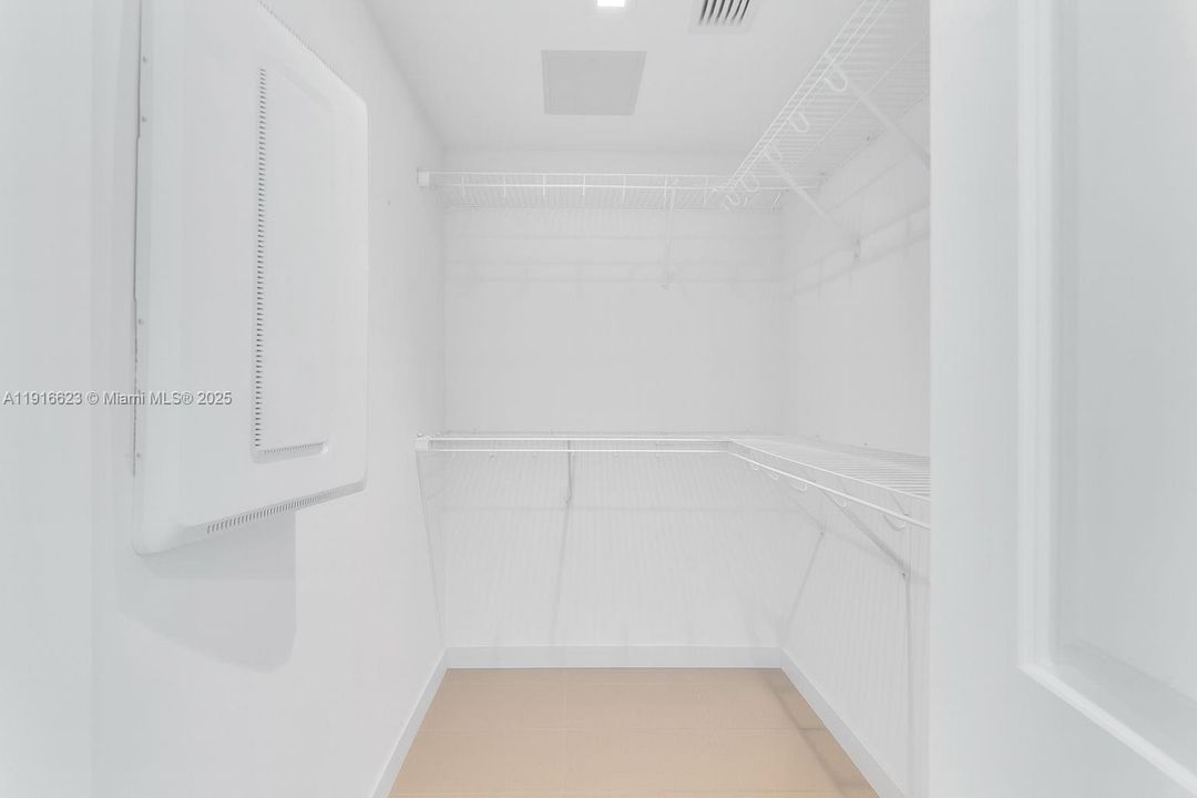 Walk in spacious master bedroom closet.