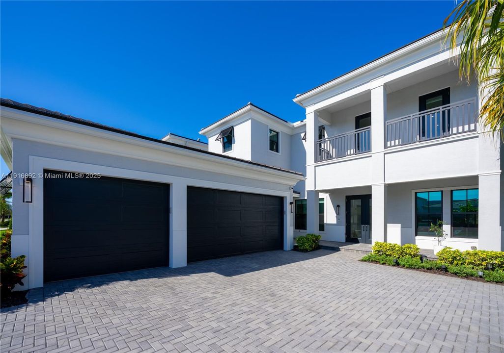 Grand 3 car garage connected to the house