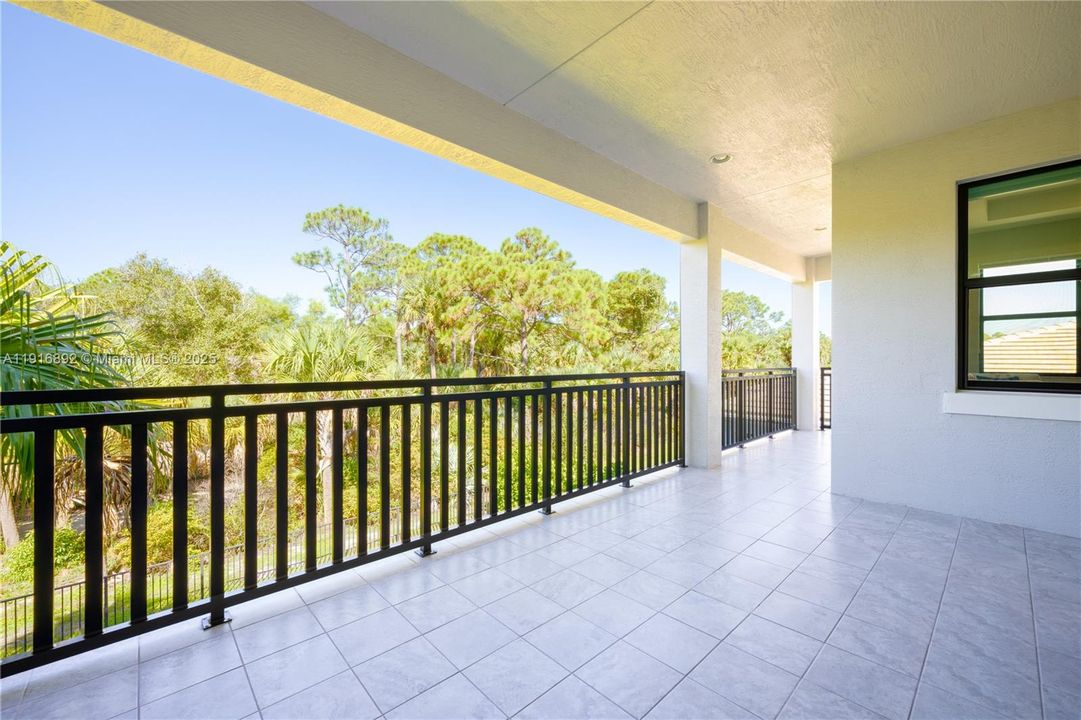 Upstairs balcony looking to attractive greenery