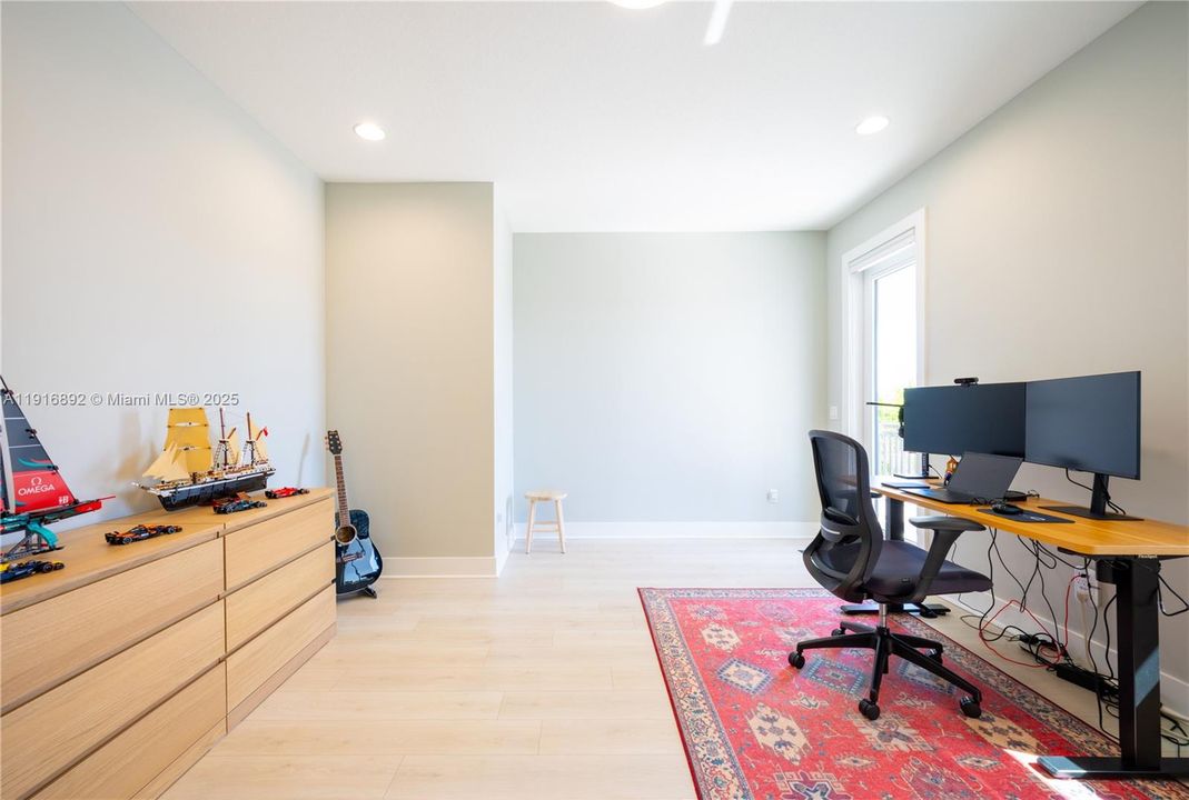 Suite 2 bedroom used as an office with access to a covered balcony