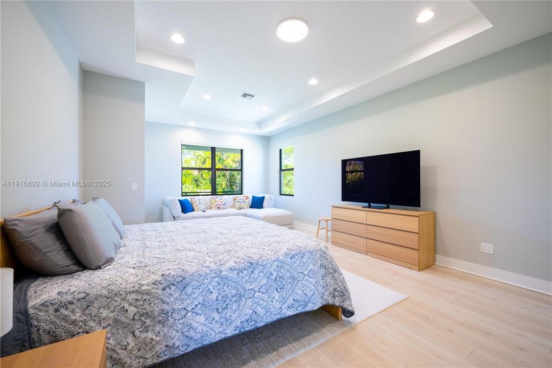 Sunlit master bedroom retreat with room to unwind