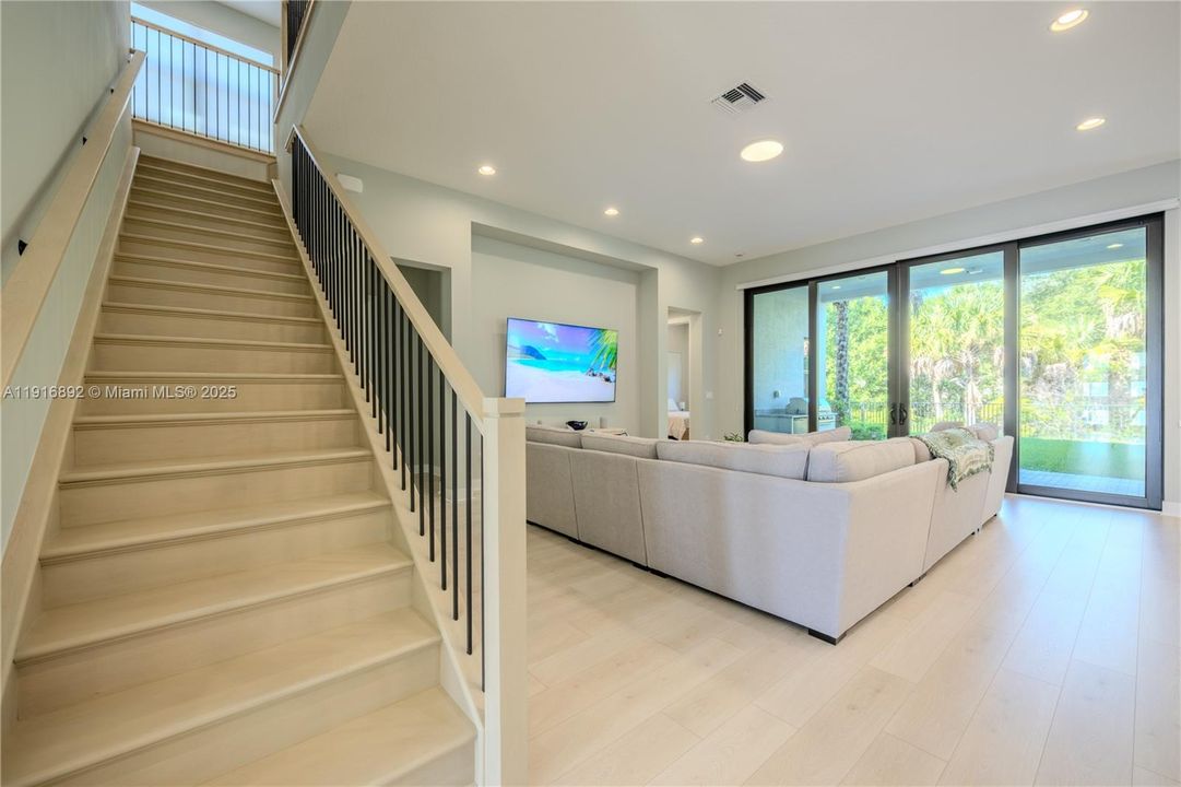 Open staircase that overlooks the bright family room
