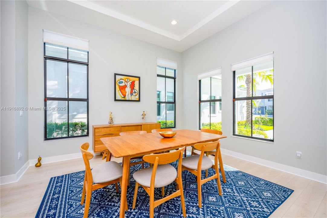 A spacious formal dining room with lots of natural light