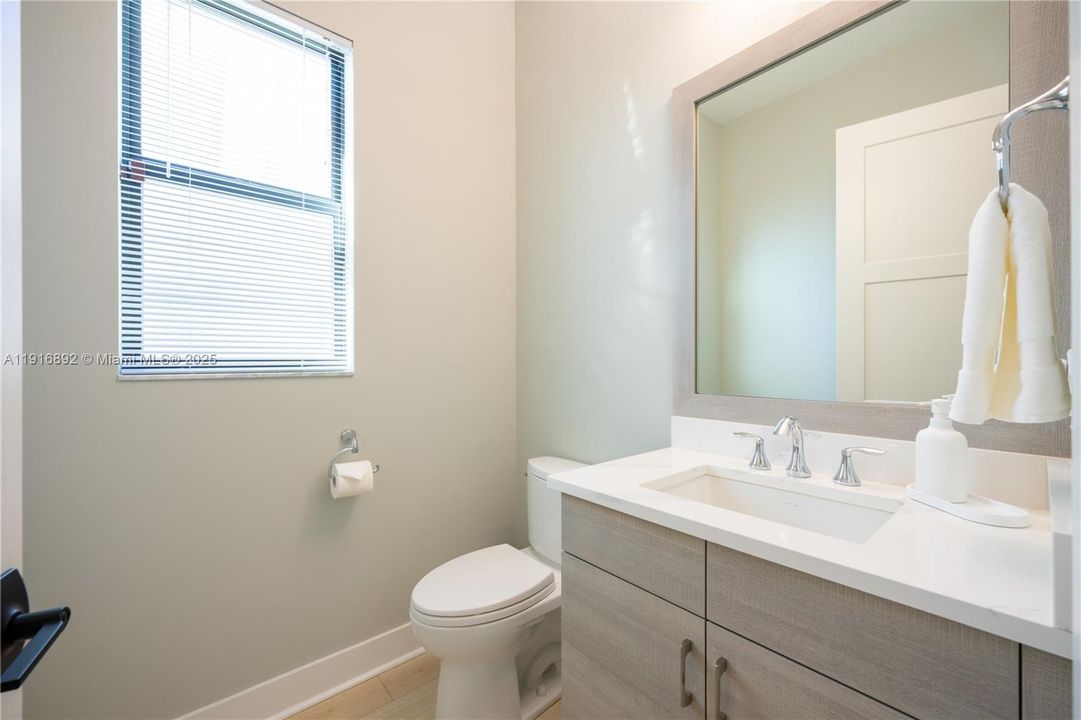 Bright powder room with quartz countertop
