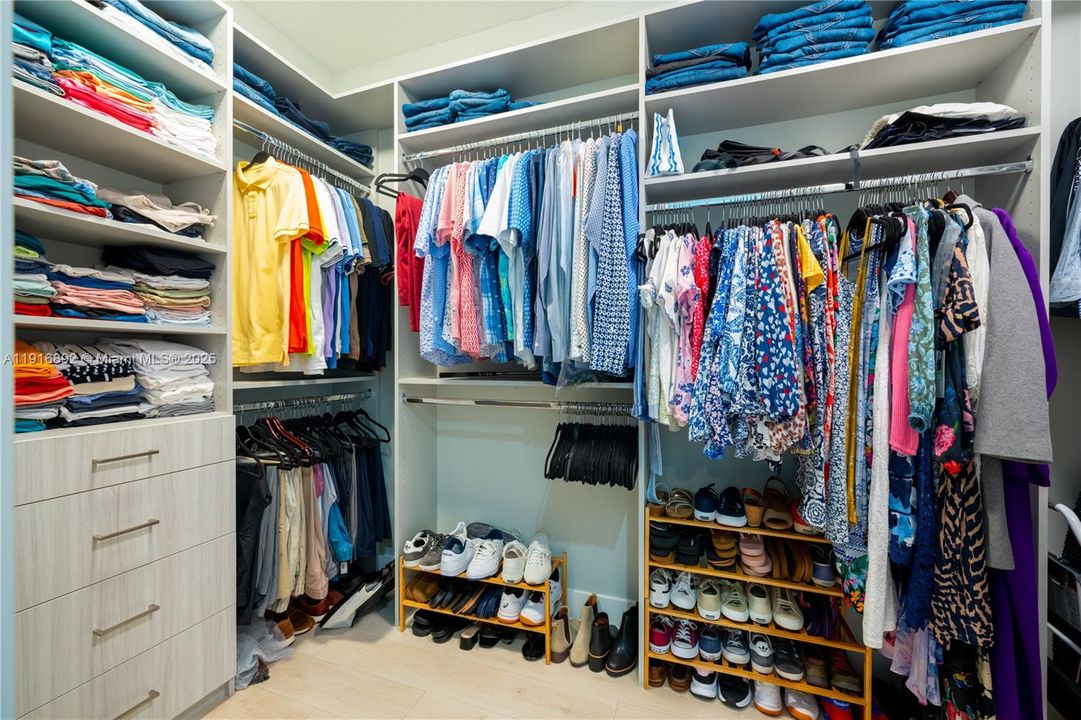 Her's spacious walk-in closet with premium shelving