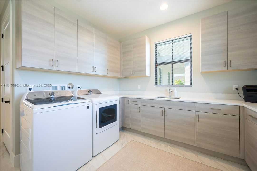 Upstairs laundry room with premium cabinetry